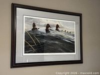 Framed print hanging on wall showing full artwork and frame
