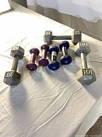 All seven dumbbells laid out showing sizes and styles