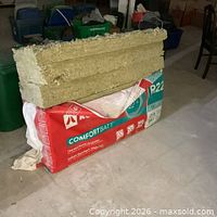 Open Rockwool ComfortBatt R22 package with batts stacked on top