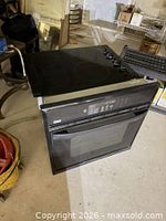 Kenmore wall oven with GE cooktop resting on top, overall view