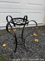 Full view of black metal plant stand front angle