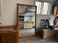 Front view of full mirror showing pine frame and reflective surface