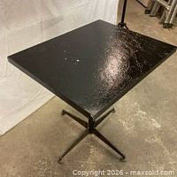 Overall view of black restaurant table