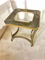 Side table angled view showing metal frame, stone tiles, glass insert
