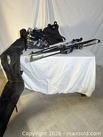 Full lot showing skis, poles, boots, boot bag, ski bag