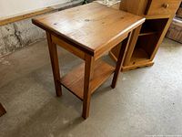 Full view of one pine side table showing top, legs, lower shelf
