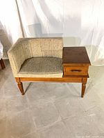 Front view of telephone bench showing upholstery, drawer, legs