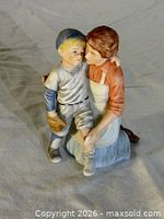 Front view of mother and son figurine