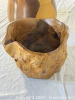 Irregular teak root bowl front with mixed-wood bowl partially visible