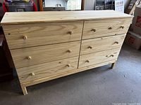 Front view showing six drawers and knob pulls