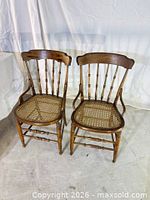 Front view of both wooden cane chairs