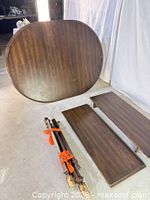 Table top, two leaves, and base parts laid out