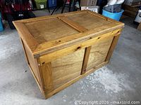 Full view of rectangular wooden chest showing lid and panels