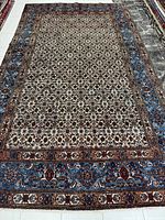 Full view of Mashhad rug showing overall pattern and colors