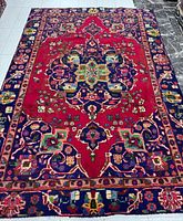 Full view of the Persian Tabriz rug showing overall pattern, colors and size