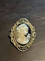 Front view showing cameo design and ornate frame