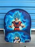 Front view of Loungefly Dragon Ball Z mini backpack showing Goku graphics and brand plaque