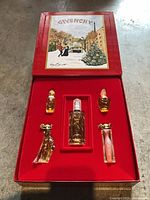 Open Givenchy box showing five miniature perfume bottles in tray