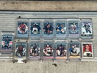 Group shot of fifteen trading cards in holders