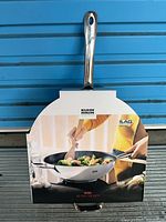 Front view of boxed Kuhn Rikon wok with sleeve graphic