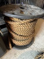 Spool with thick natural fiber rope wound around it