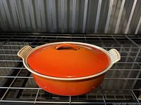 Top view of orange Le Creuset oval casserole with lid