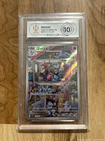 Front of graded Machoke card showing holographic artwork and APH grade 10 label