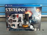 Front of sealed PS4 Starlink: Battle for Atlas starter pack showing contents through window