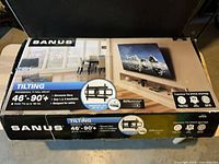 Retail box front showing Sanus premium tilting TV wall mount specifications 46–90+ inch
