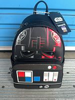 Front view of Darth Vader themed Loungefly mini backpack showing helmet graphic and chest-panel pocket