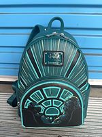 Front view showing Star Wars Loungefly logo plaque and cockpit artwork