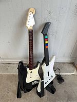Front view of both guitar controllers standing side by side