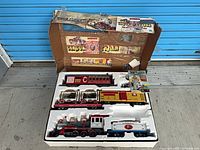 Full set in original box with foam insert showing all rolling stock and pamphlet