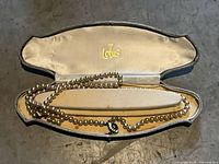 Necklace displayed inside Lotus branded case
