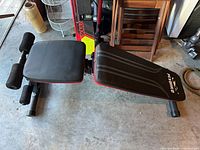 Overall view of Flybird workout bench showing seat, backrest, leg rollers and steel frame