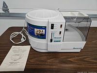 Humidifier with power cord and manual on table