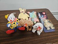 Front view of all six bears including packaged Glory and five loose bears