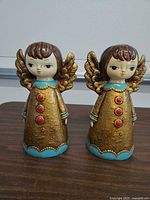 front view of both ceramic angel coin banks