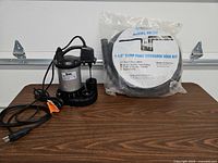 Pump and sealed hose kit displayed together on table