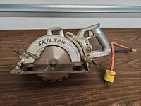 Full view of Skil SKILSAW 77 circular saw showing body, blade, cord and yellow plug