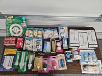 Overview of all packaged light bulbs laid out on table