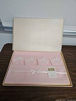 Boxed set showing centerpiece and four folded napkins