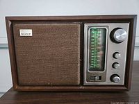 Front view showing speaker grille, tuning dial, control knobs, Sony badge