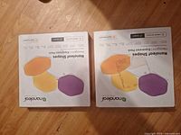 Front view of two sealed Nanoleaf Shapes Hexagons Expansion Pack boxes