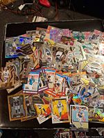 Wide view of sizable pile of assorted football trading cards showing various Panini Select parallels, Score cards, other prism variations
