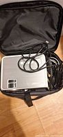 Projector in carry case with cables visible