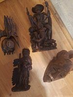 Overall view of four wood carvings and mask