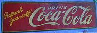 Full view of red Coca-Cola tin sign