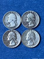 Obverse view of four Washington quarters dated 1935, 1944, 1957, 1964