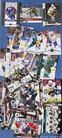 pile of assorted NHL trading cards spread out, showing player fronts and card brands